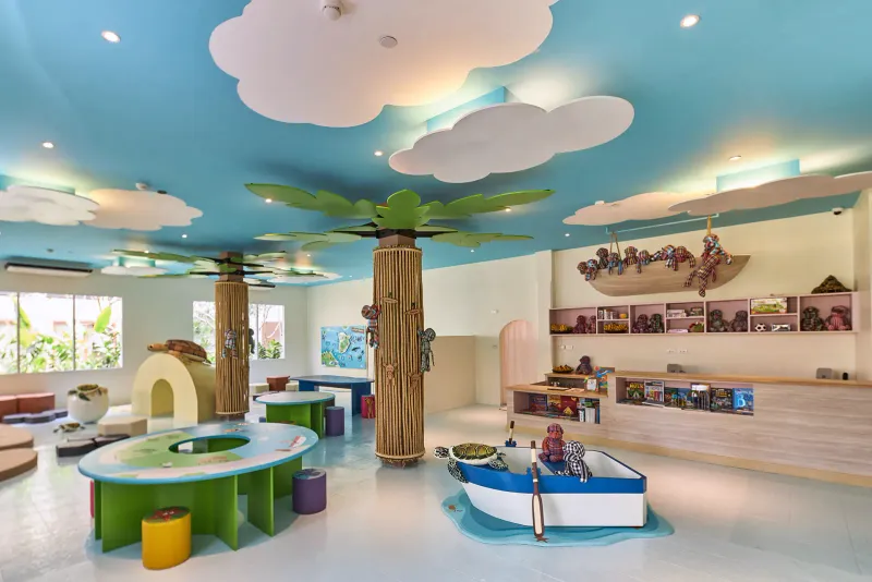 Monkey Club kids room at Bandara Resort Samui with a palm-tree pillar, cloud ceiling and toy boat