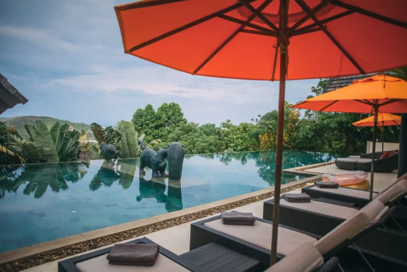 Sun loungers and umbrellas beside a resort pool near Bophut Koh Samui