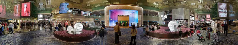 Interior of Singapore Changi Airport terminal with passengers walking through the concourse