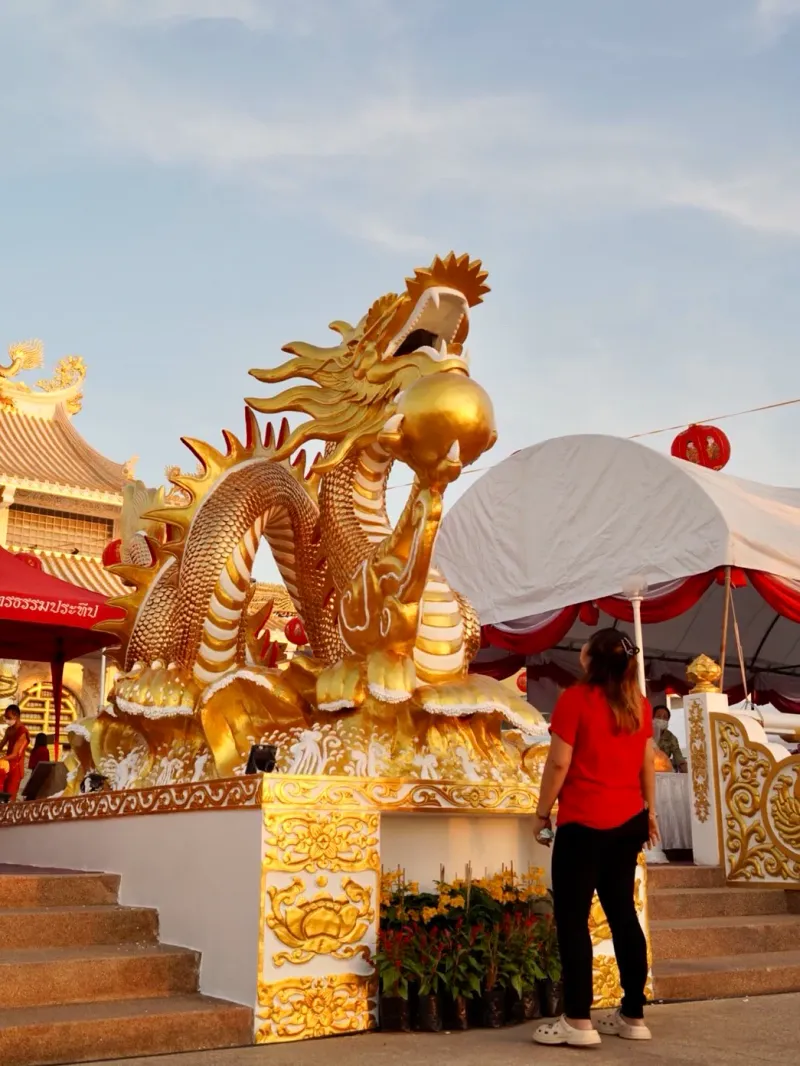 Red-and-gold dragon gate of the shrine complex at sunset