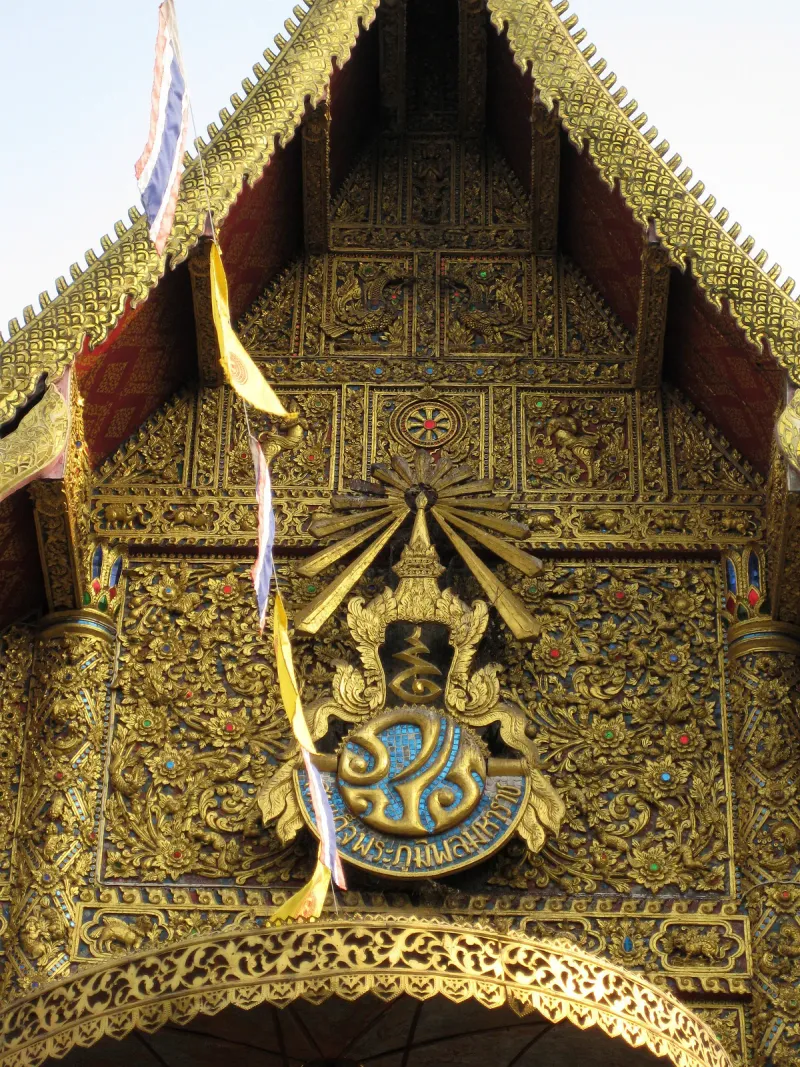 Gilded Buddhist carving on the facade of Wat Buppharam in Chiang Mai old city