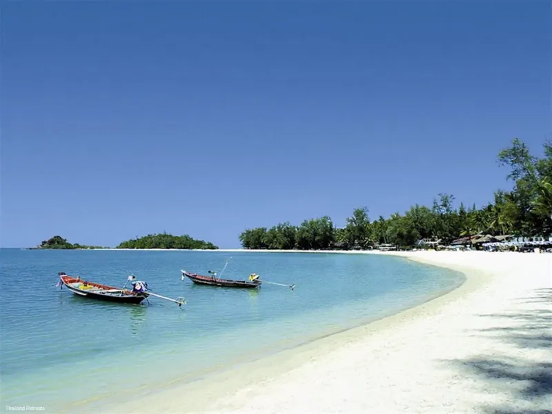 Longtail boats anchored off the sand at Choeng Mon Beach