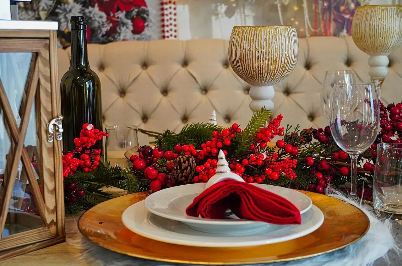 Festive Christmas table setting with a red napkin and berries