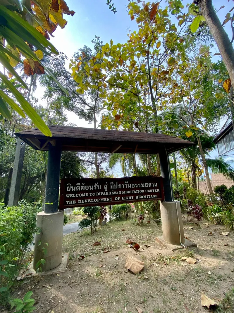 Welcome sign at the entrance reading Dipabhavan Meditation Center, the Development of Light Hermitage