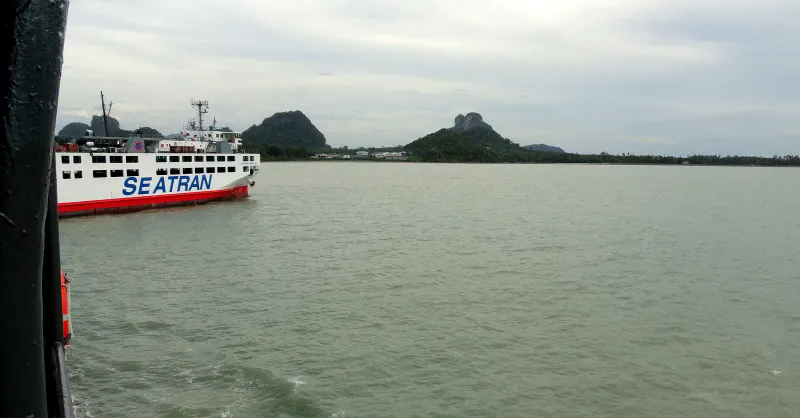 Seatran car ferry crossing the Gulf of Thailand with green limestone hills on the horizon