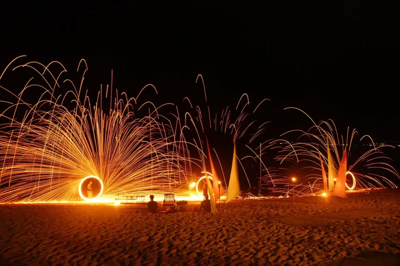 A steel wool fire show on a beach in Thailand at night