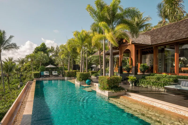 Long tiled villa pool with Thai pavilion and palm terraces on the hillside at Four Seasons Resort Koh Samui