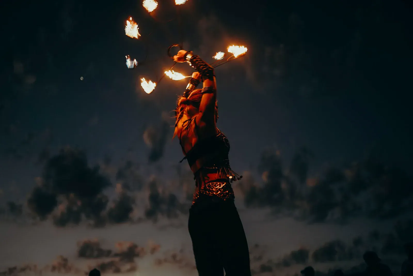 Fire dancer on a beach at night