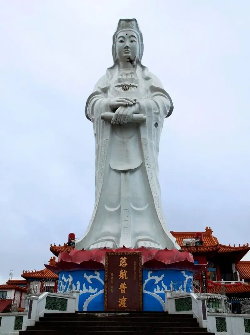 Explore the towering Guanyin statue at a traditional temple in Taiwan, showcasing Buddhist art