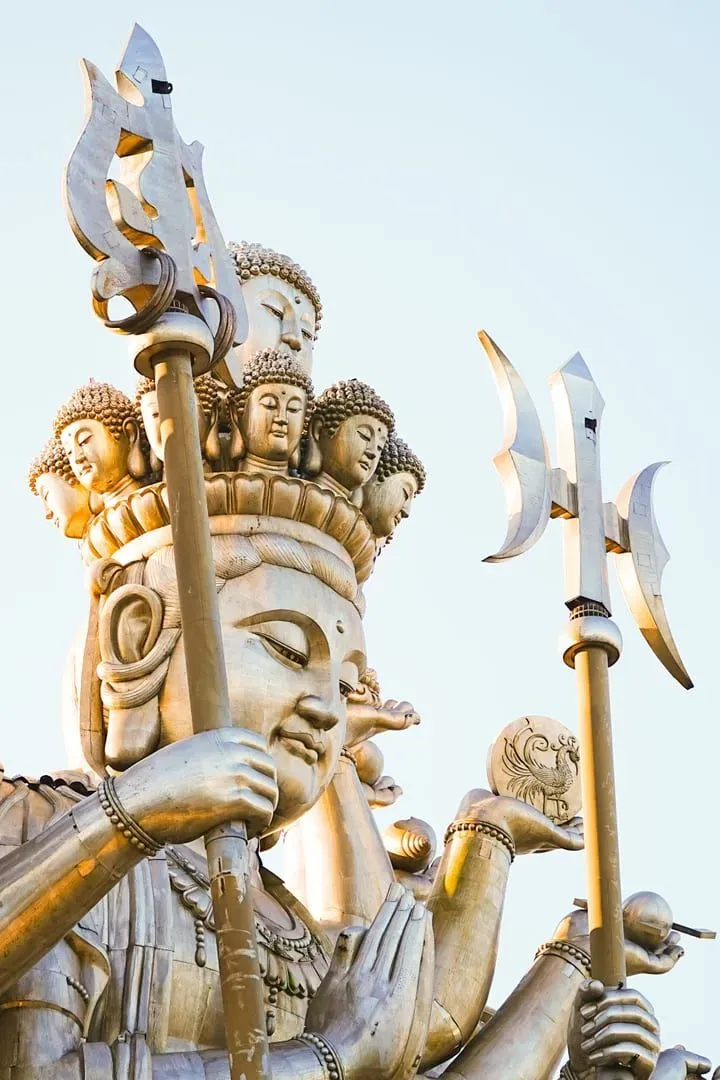 Dramatic close-up of a Thousand Hands Guanyin statue, capturing intricate details and spiritual symbolism