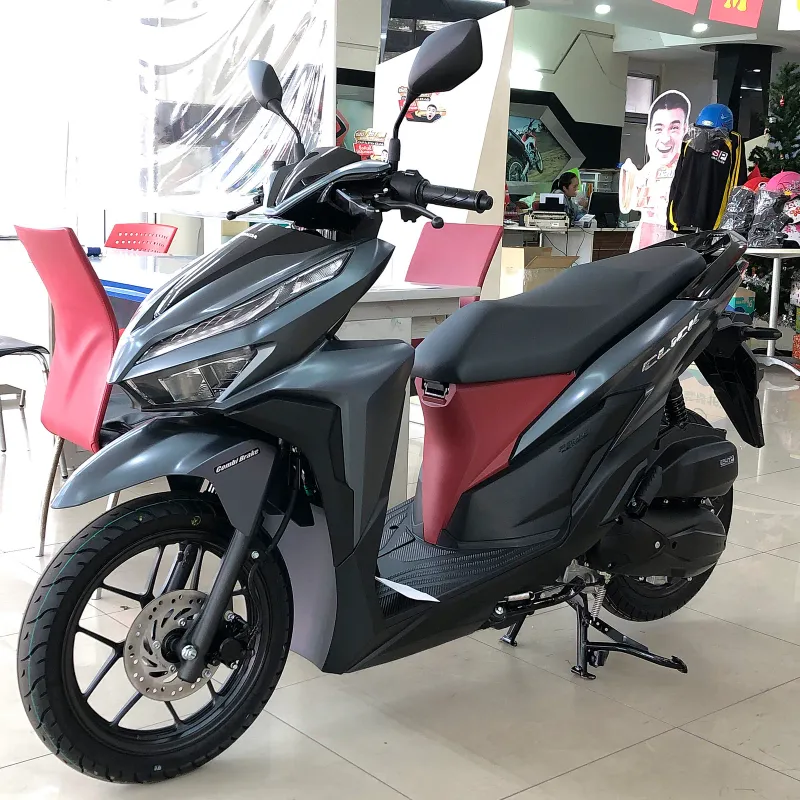 New matte grey Honda Click scooter on a showroom floor in Thailand
