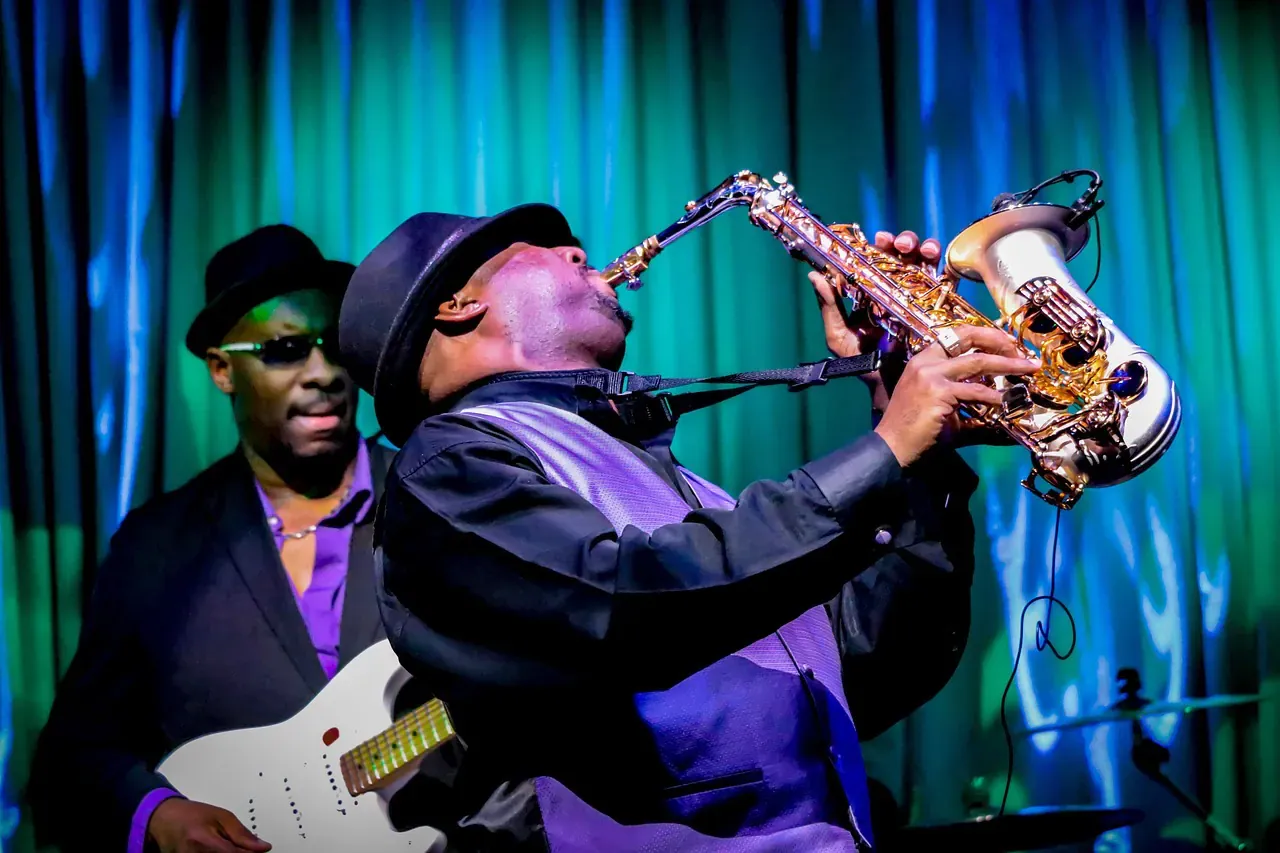 Saxophonist performing on a club stage
