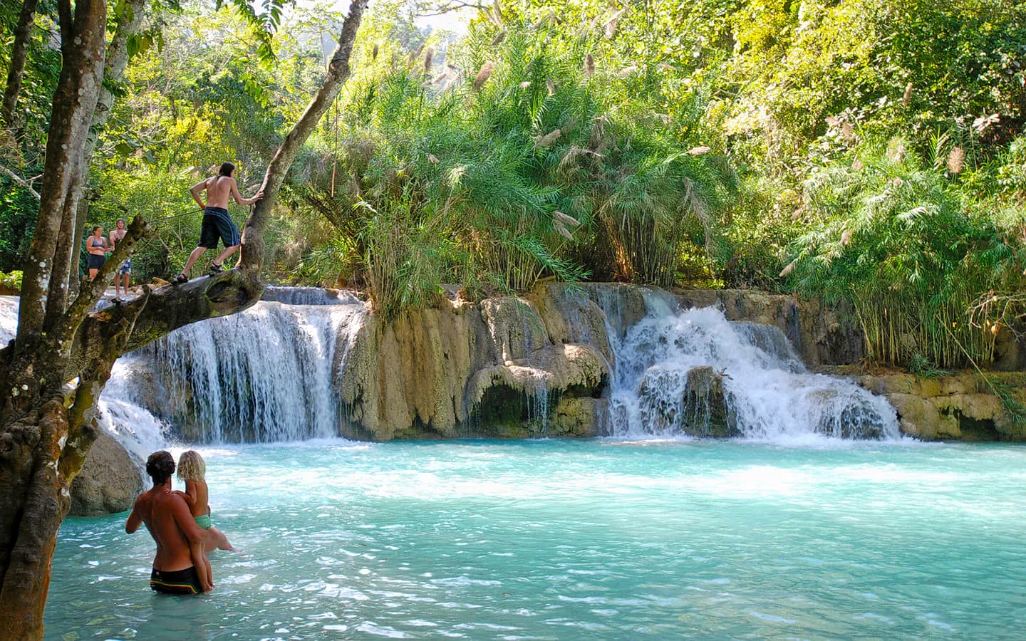 Sunlight catching the spray at Khun Si Waterfall's main pool