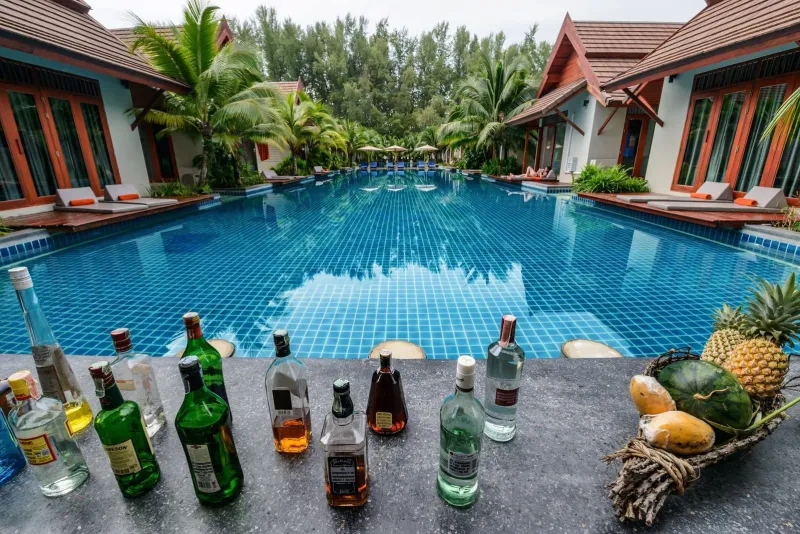 Poolside lounge area with tropical drinks at a Koh Samui luxury resort