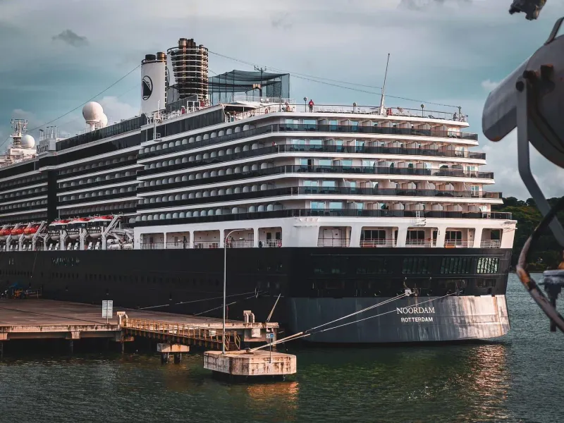 Large cruise ship anchored under a dramatic sky, representative of ships that stop offshore at Koh Samui