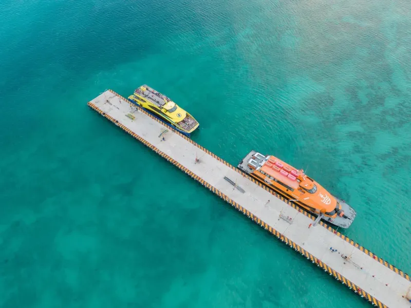 Aerial view of boats moored at a tropical pier comparable to Koh Samui's coastline