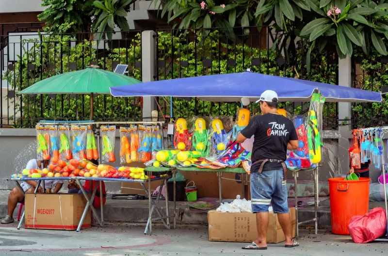 Colourful water guns for sale at a street stall ahead of Songkran, Thailand's water festival