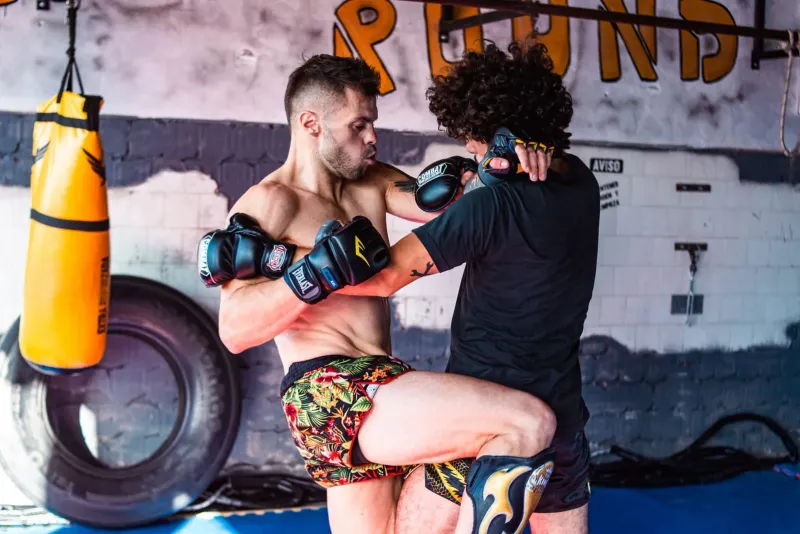 Two fighters sparring inside a Muay Thai gym ring, the kind of session available at Superpro Samui