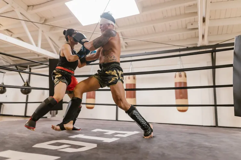 Two fighters sparring with pads in a ring, generic illustration of drop-in training style at Samui gyms