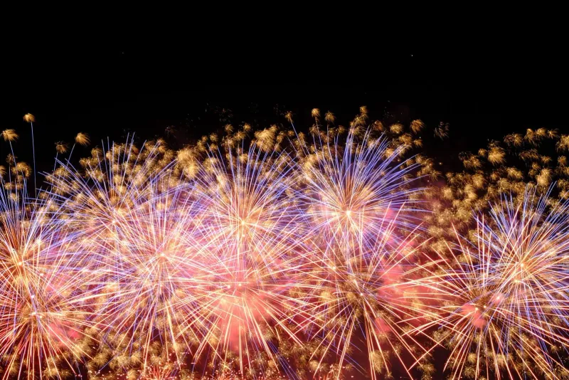 Vibrant fireworks bursting over the night sky during a New Year's Eve countdown celebration on Koh Samui