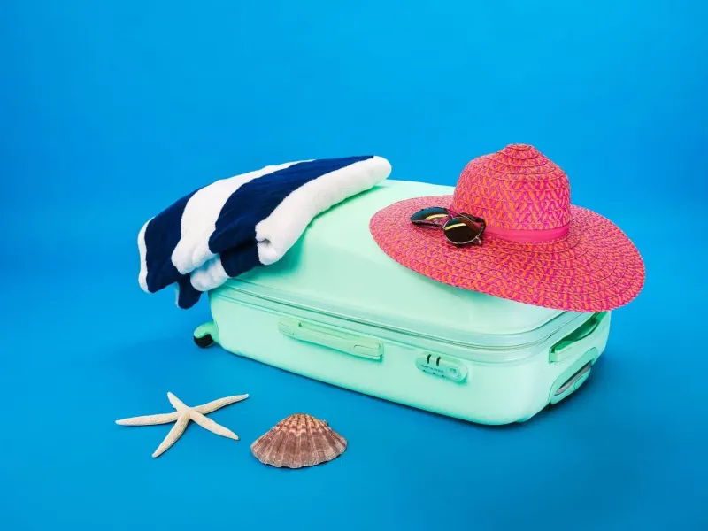 Packed suitcase and beach essentials laid out for a family trip to Koh Samui