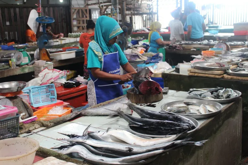 Vendor preparing food at a wet market on Koh Samui