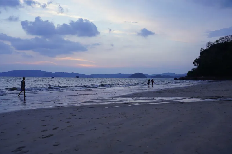 Beach at dusk near Ao Nang in Krabi with limestone islands on the horizon