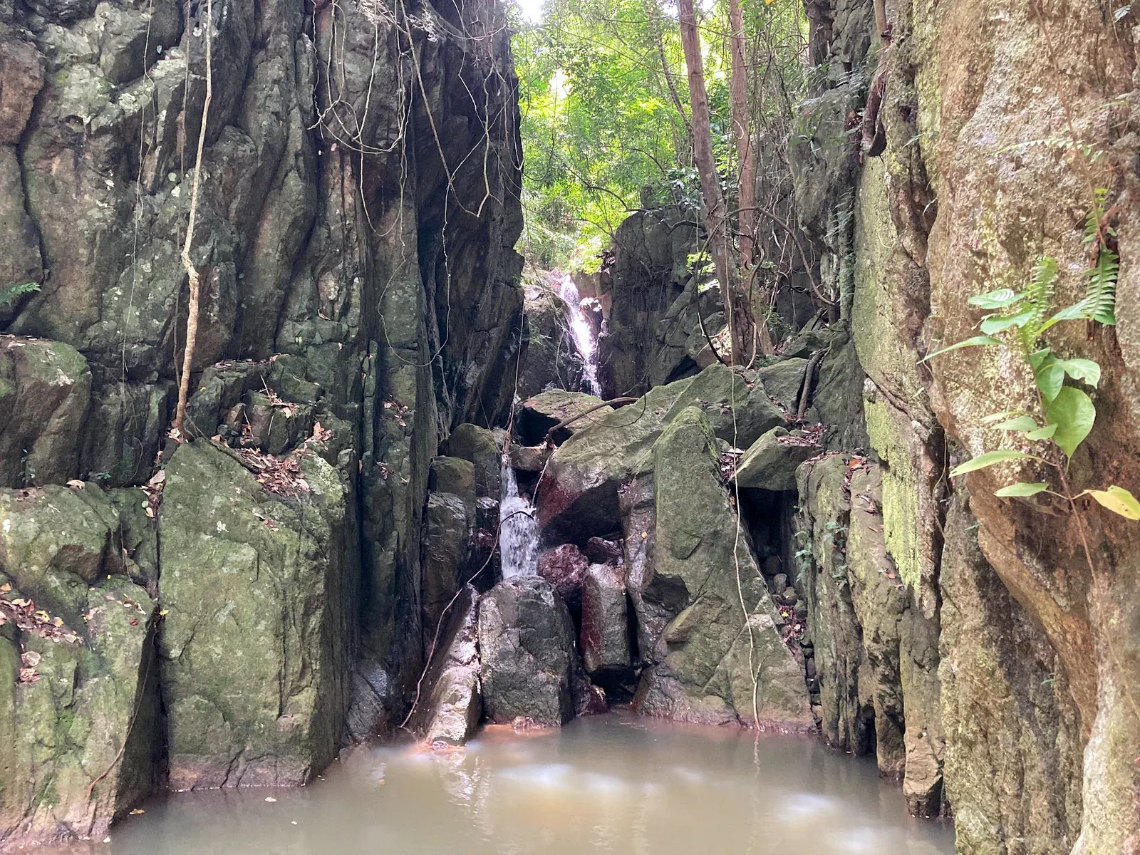 Water stepping down tiered rock formations at Lat Wanon Waterfall