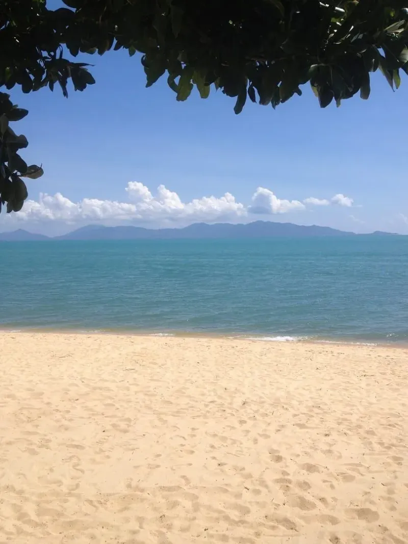 View across the strait toward distant mountains from Maenam Beach, Koh Samui