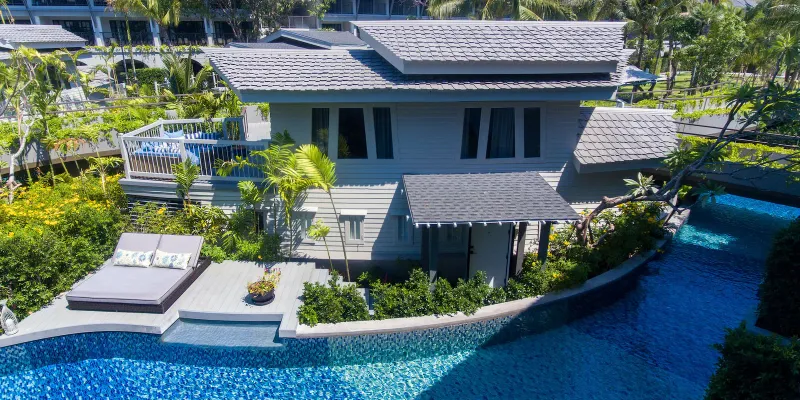 Pool-side suite with sunbed deck beside the lagoon channel at Melia Koh Samui seen from above