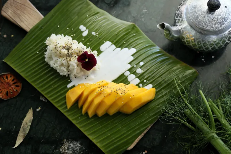 Mango sticky rice on a banana leaf