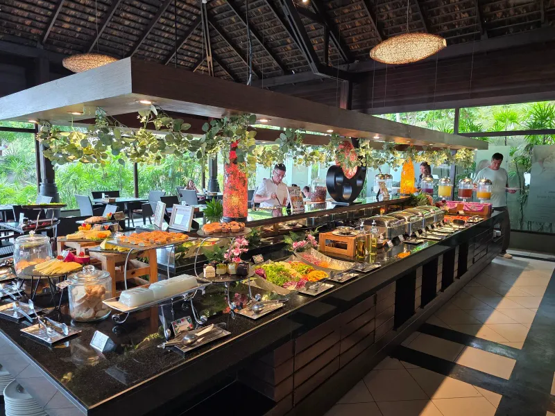 Breakfast buffet counter with hot dishes and chefs at Nora Buri Resort