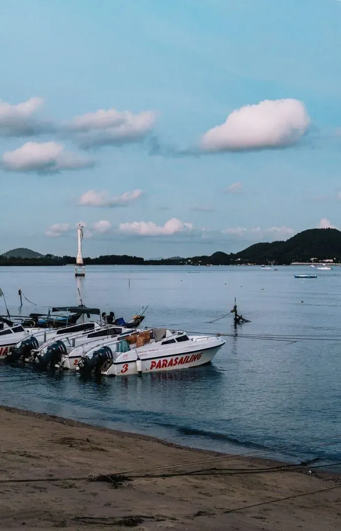 Boats moored on a sandy beach at dusk, typical of the Andaman coast