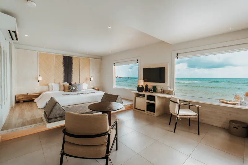 Bedroom at Rocky's Boutique Resort on Koh Samui with a king bed and a wide window onto the sea