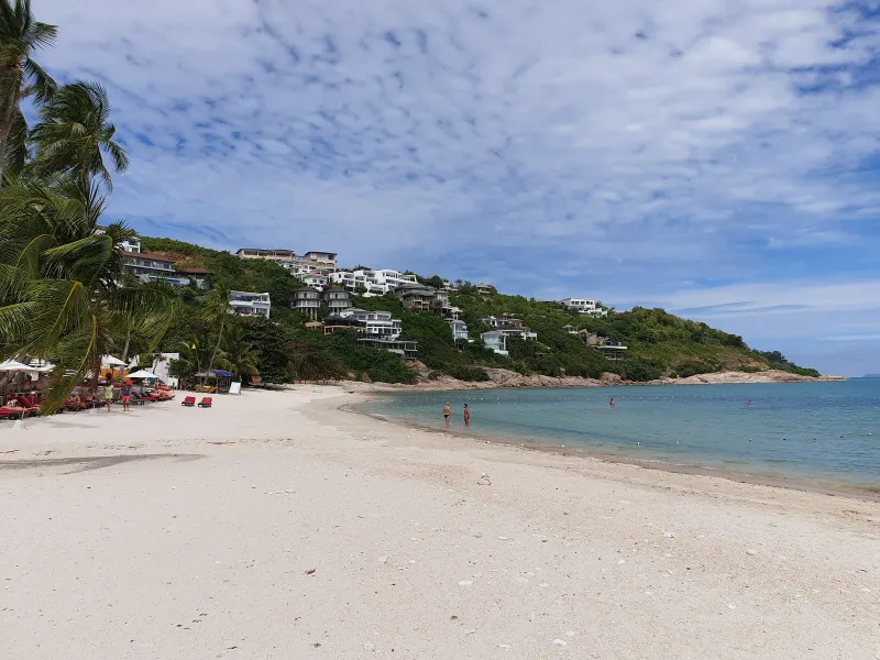 Curving white sand at Thongson Bay backed by hillside resort villas