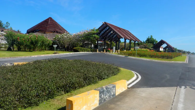 Open-air timber roofed terminal entrance at Samui International Airport on a clear day