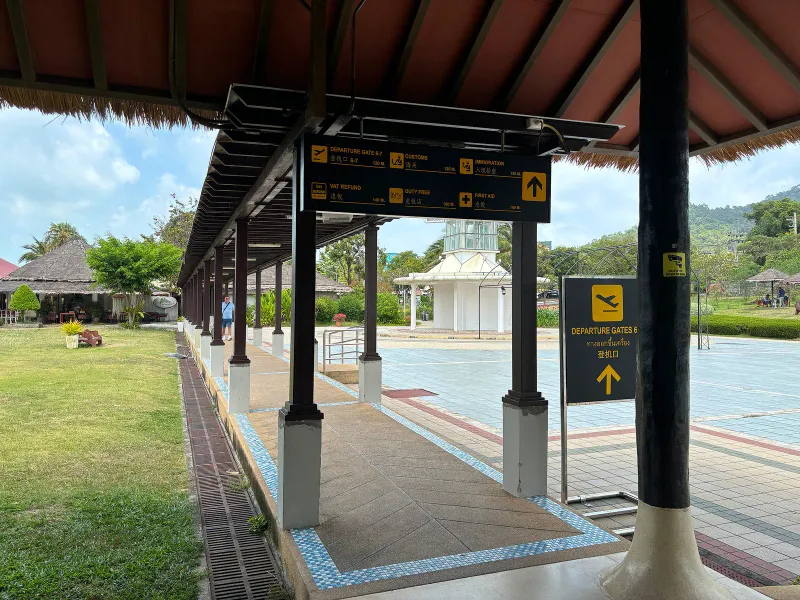 Landside corridor to the international gate at Samui Airport, where check-in and gift shop areas sit