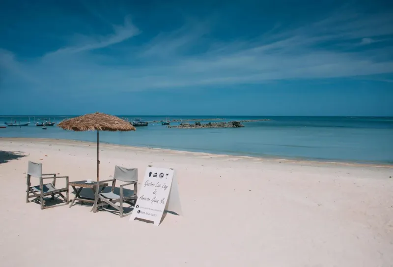 Calm, shallow water and beach loungers on a family-friendly Koh Samui beach