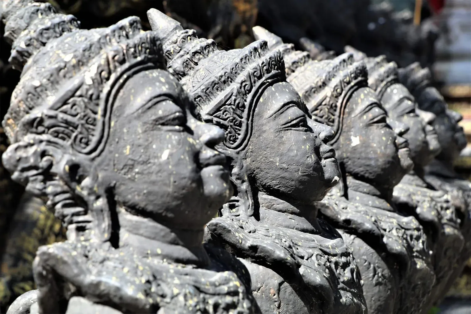 Moss-covered stone statues at the nearby Secret Buddha Garden, a common pairing with the Khao Nui hike