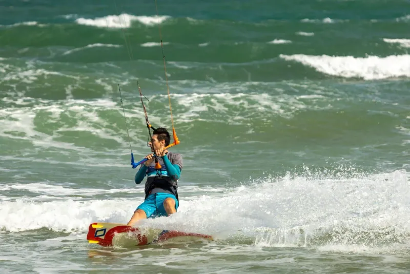 Kiteboarder throwing spray during a southwest monsoon session near Koh Samui