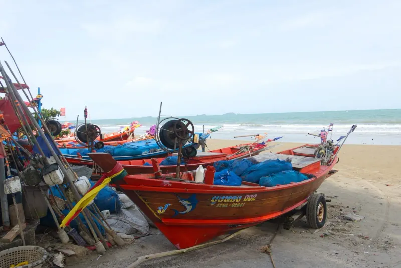 Colorful traditional fishing boats resting on a Thai beach