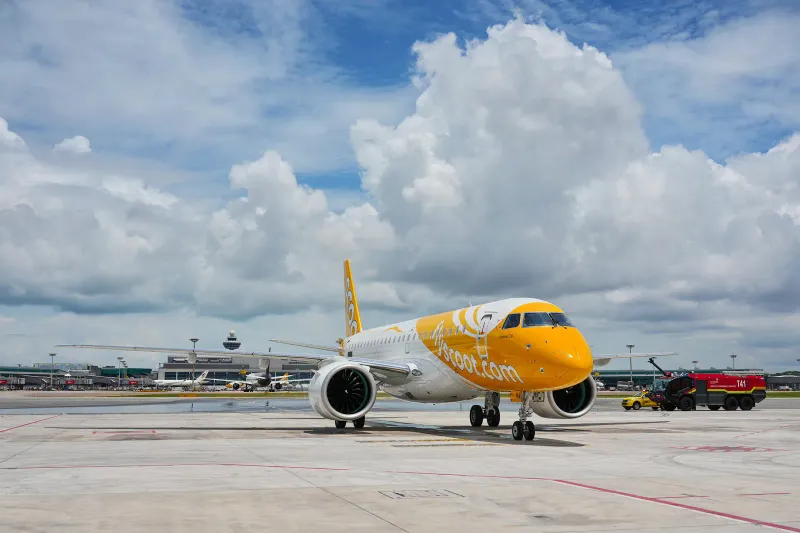 Yellow Scoot Embraer E190-E2 jet on the apron at Singapore Changi Airport