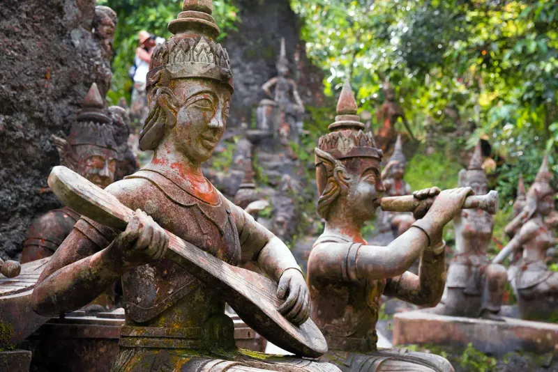 Musician statues among the rocks of Tarnim Magic Garden