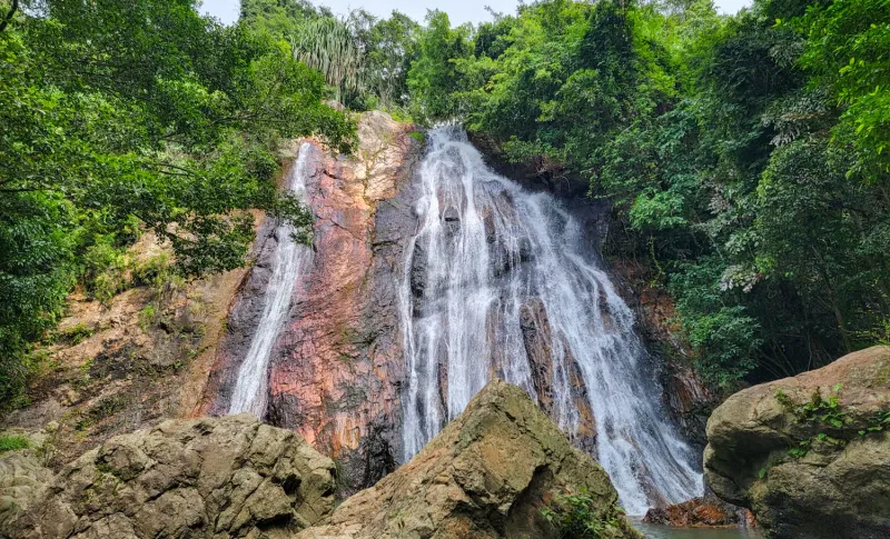 Wide jungle waterfall framed by tropical greenery on Koh Samui