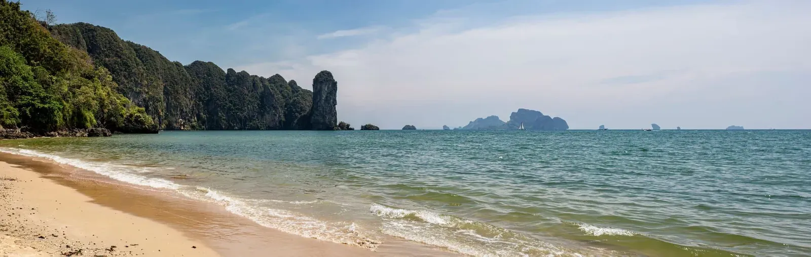 A tropical cliff panorama over turquoise sea, the kind of coastal view the boulder platform looks out on (illustrative)