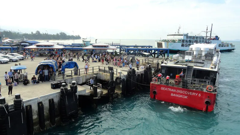 Seatran Discovery catamaran moored at a pier while passengers wait on the quay