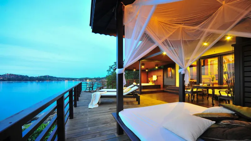 Infinity pool on a private deck overlooking the cove and the sea beyond