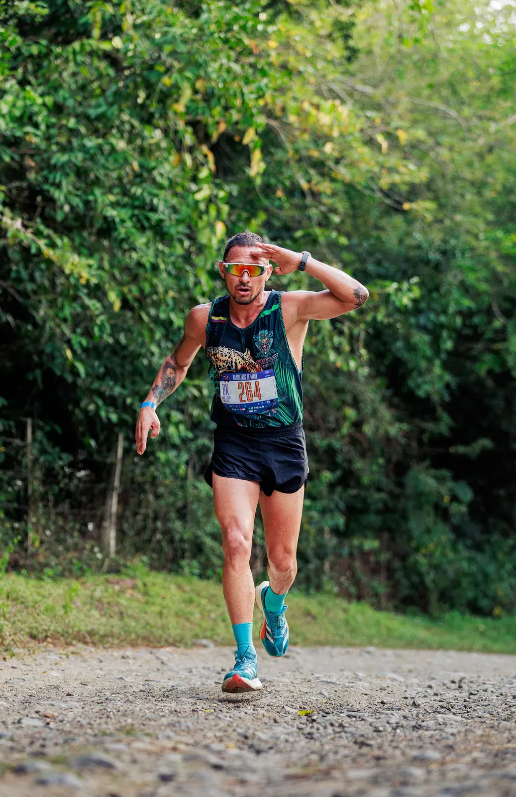 Trail runner pausing on a forest trail