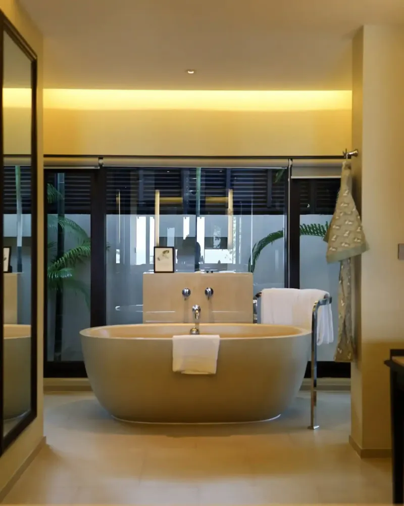 Suite bathroom at Vana Belle with a freestanding bathtub and warm lighting