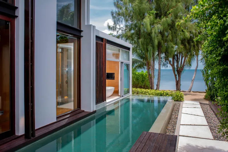 Private plunge pool of a W Koh Samui villa with stepping stones leading to a beach and the sea